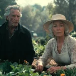 Elderly couple in a serene garden, woman in sunhat planting flowers while man stands nearby